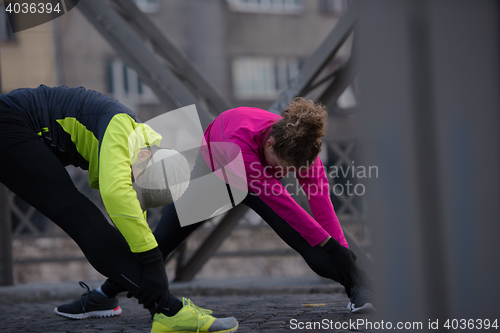 Image of couple warming up before jogging