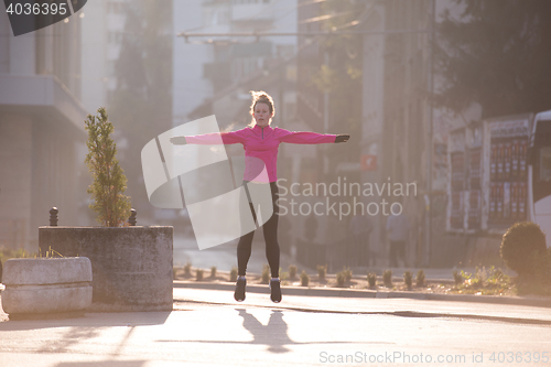 Image of woman  stretching before morning jogging