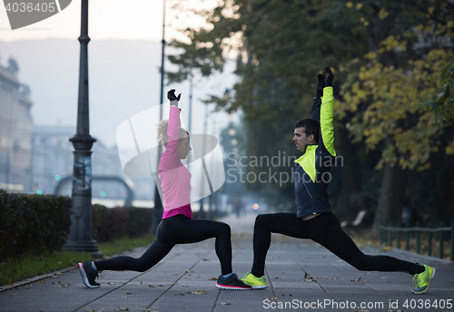 Image of couple warming up before jogging