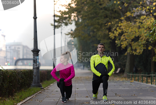 Image of couple warming up before jogging