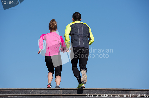 Image of young  couple jogging on steps