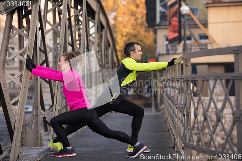 Image of couple warming up before jogging