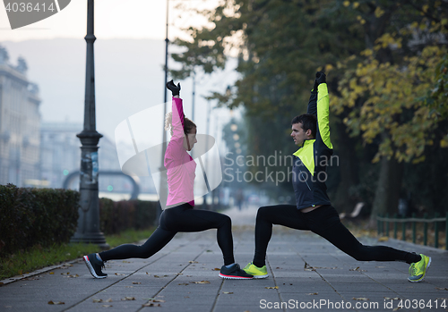 Image of couple warming up before jogging