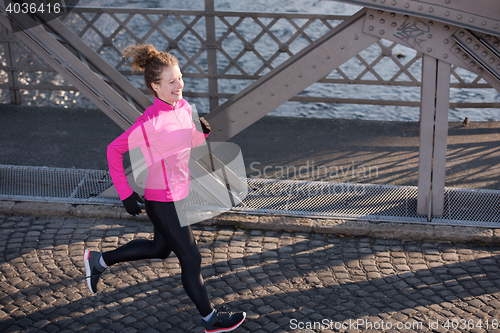 Image of sporty woman jogging on morning