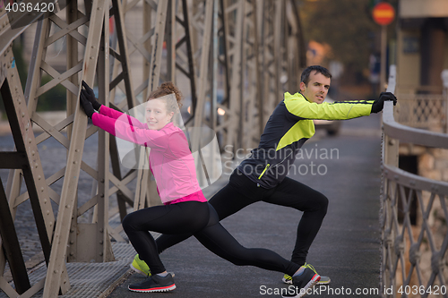 Image of couple warming up before jogging