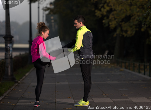 Image of couple warming up before jogging