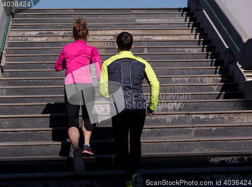 Image of young  couple jogging on steps