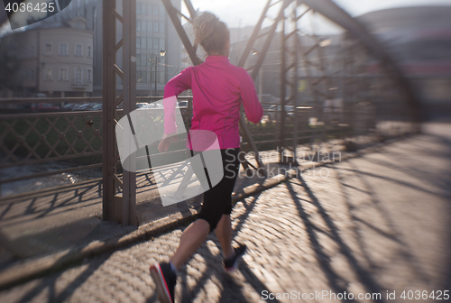 Image of sporty woman jogging on morning