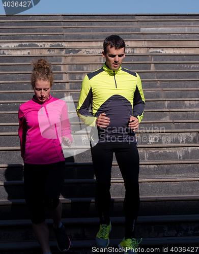 Image of young  couple jogging on steps