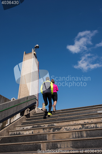 Image of young  couple jogging on steps