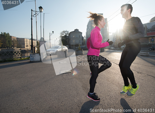 Image of couple warming up before jogging