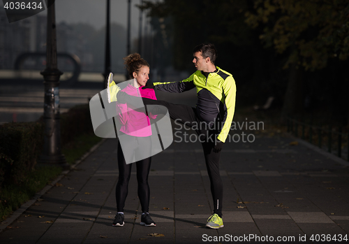 Image of couple warming up before jogging