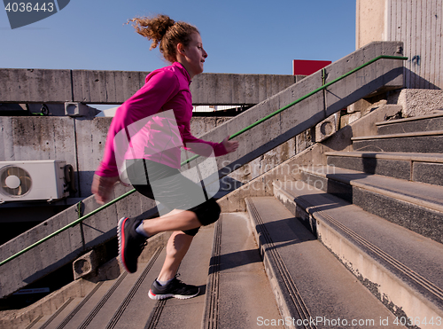 Image of woman jogging on  steps