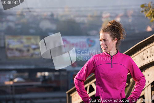 Image of woman  stretching before morning jogging