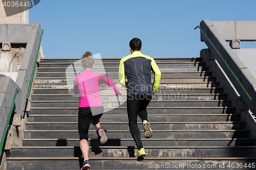 Image of young  couple jogging on steps