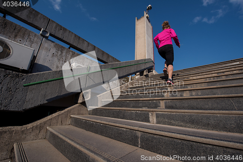 Image of woman jogging on  steps