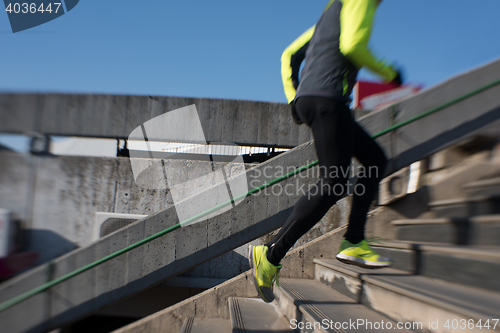 Image of man jogging on steps