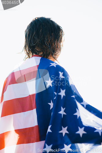 Image of Back view of wet-haired woman in american flag