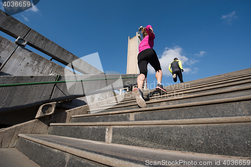 Image of sporty woman jogging on morning