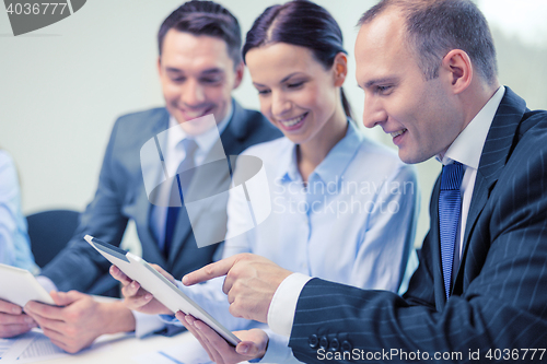 Image of business team with tablet pc having discussion