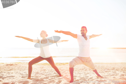 Image of couple making yoga exercises outdoors