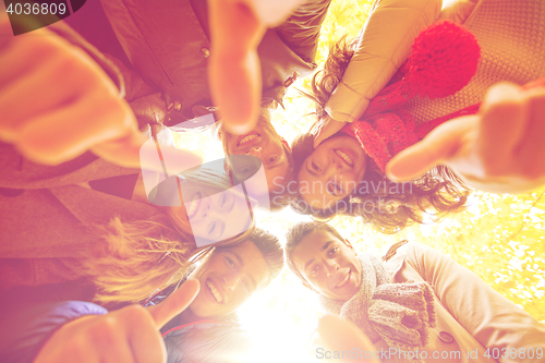 Image of group of smiling men and women in autumn park