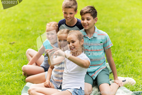 Image of happy kids or friends taking selfie in summer park