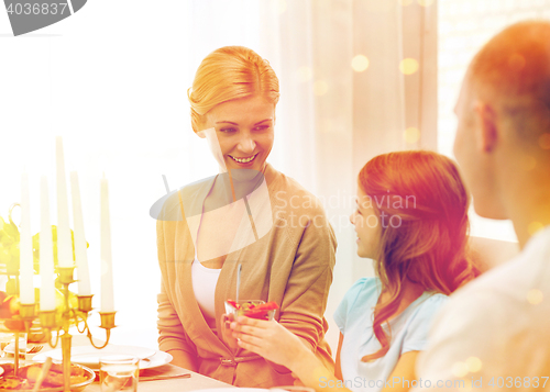 Image of smiling family having holiday dinner at home