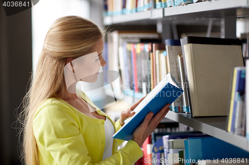 Image of high school student girl reading book at library