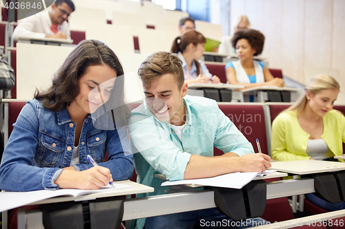 Image of group of students with notebooks at lecture hall