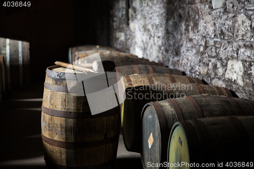 Image of close up of old wooden barrel in wine cellar