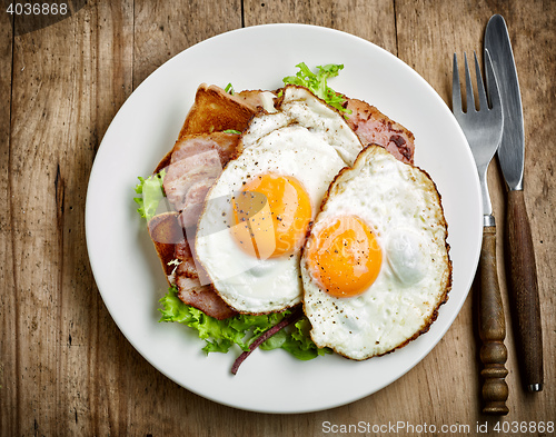 Image of fried eggs on white plate