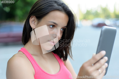 Image of Girl using tablet PC outdoor