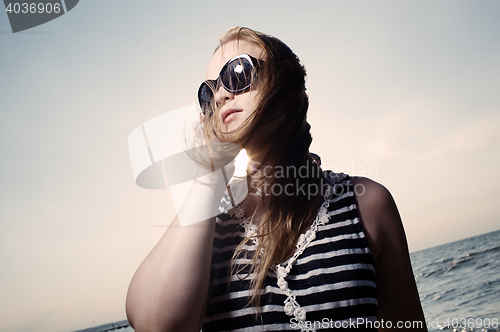 Image of Talking on the phone with sun behind