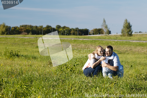 Image of Family of three having fun outdoors