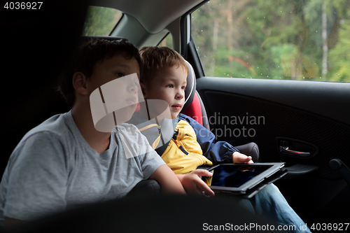 Image of Two boys in the car with tablet PC