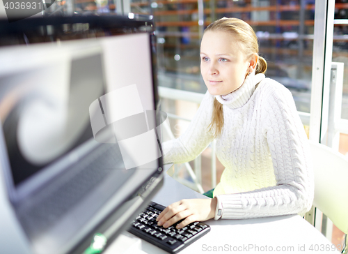 Image of Young girl is choosing the notebook.