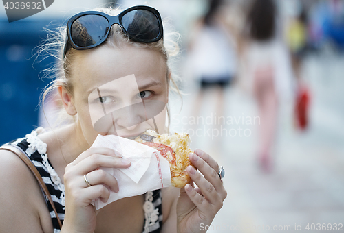 Image of Young woman eating