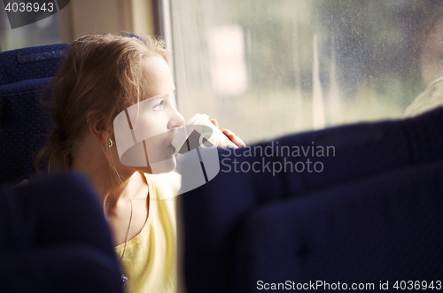 Image of Pensive woman traveling by train
