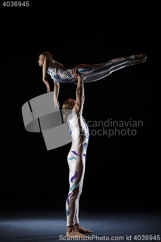 Image of Circus artists perform different tricks.