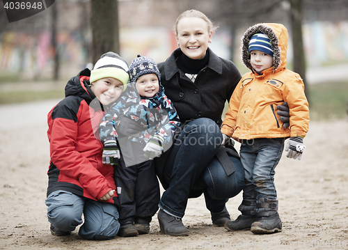 Image of Happy mother with her three young children