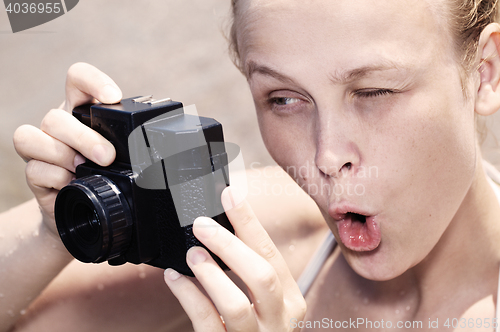 Image of Woman photographer pulling a comical face