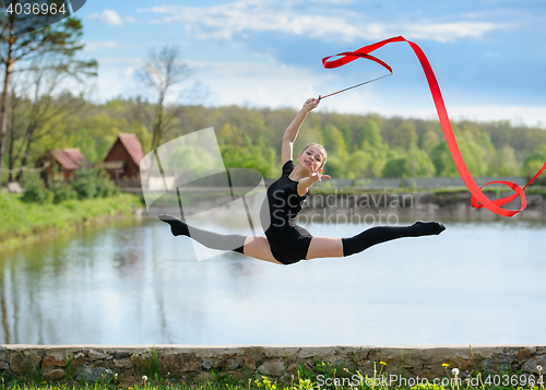 Image of Young Gymnast Shows Split Jump