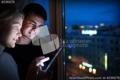 Image of Friends with Tablet PC by Window