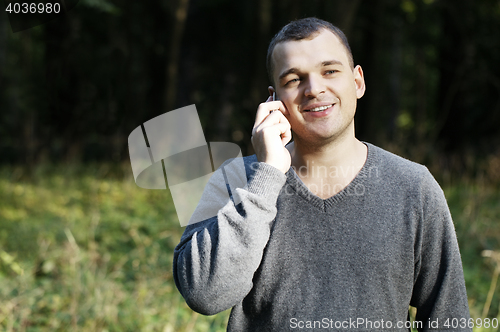 Image of Man laughing as he chats on his mobile