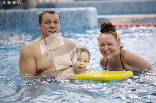 Image of Grandparents and a grandson in the swimming pool