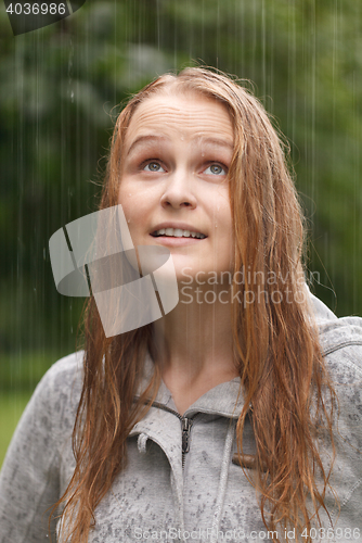 Image of Girl enjoying rain in the park.