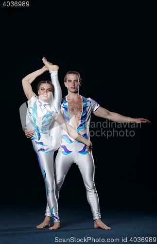 Image of Circus artists perform different tricks.