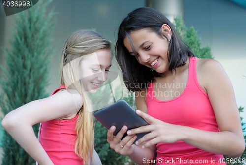 Image of Two teen girls with tablet PC