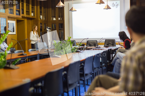 Image of Student presenting his study work in front of whiteboard.